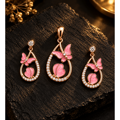 Butterfly pendant and earrings set illuminated on textured black slate background.
