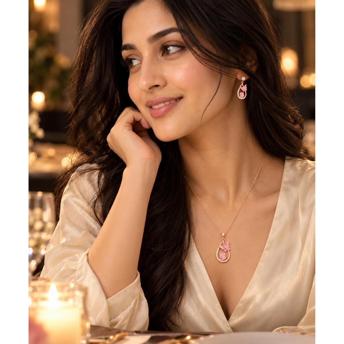 Close-up of Noya in a cream blouse wearing the rose gold butterfly teardrop jewellery set.
