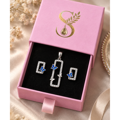 Silver blue butterfly jewellery set displayed inside a magenta pink velvet-lined Silvanya gift box.