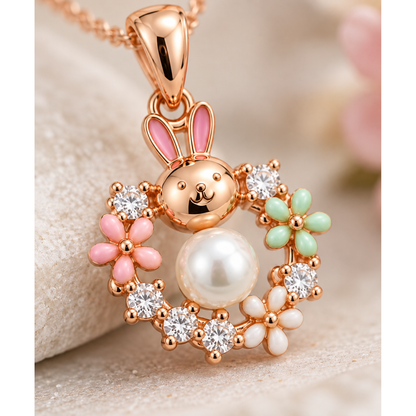 Detailed close-up of a central pearl and enamel floral detailing on rose gold jewellery.