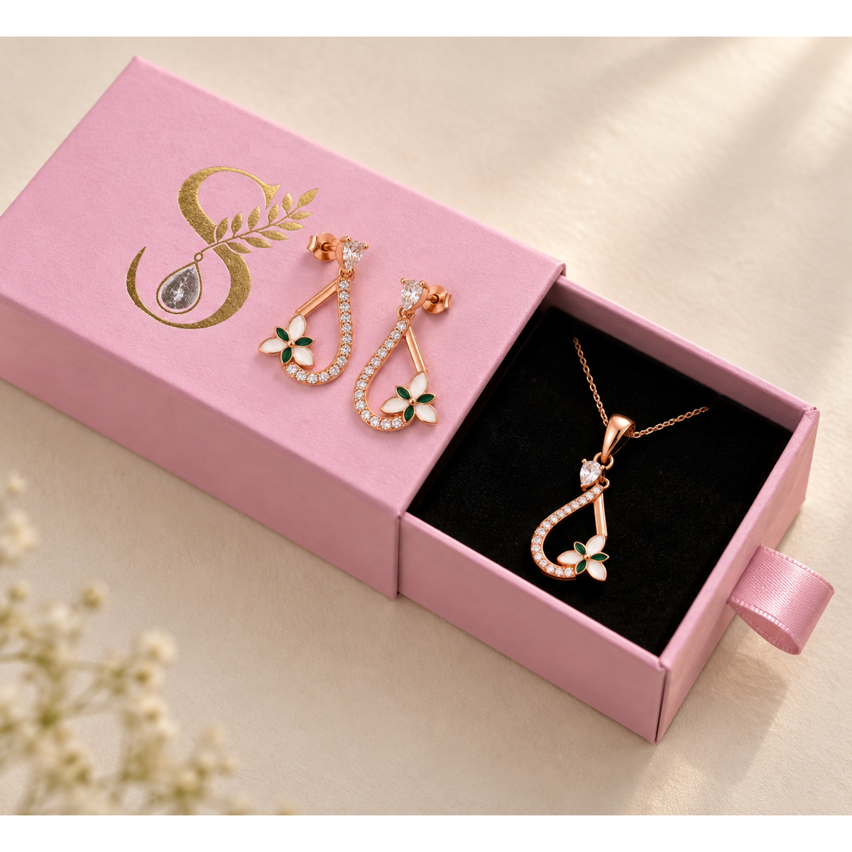 Magenta Silvanya drawer box half open with the pendant inside and earrings on the lid.