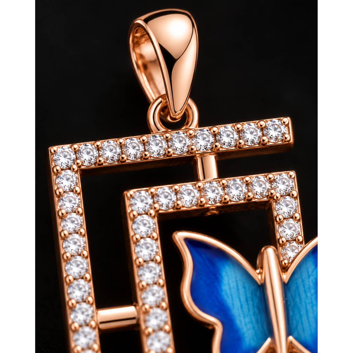Extreme close-up of the stone-set pendant frame and bail, filling the frame.