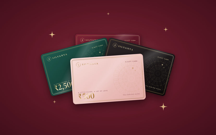 Four Silvanya e-gift cards in blush, maroon, emerald and black with gold foil